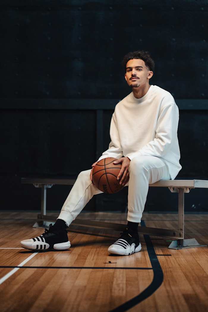 Trae Young modeling new black and white shoes.